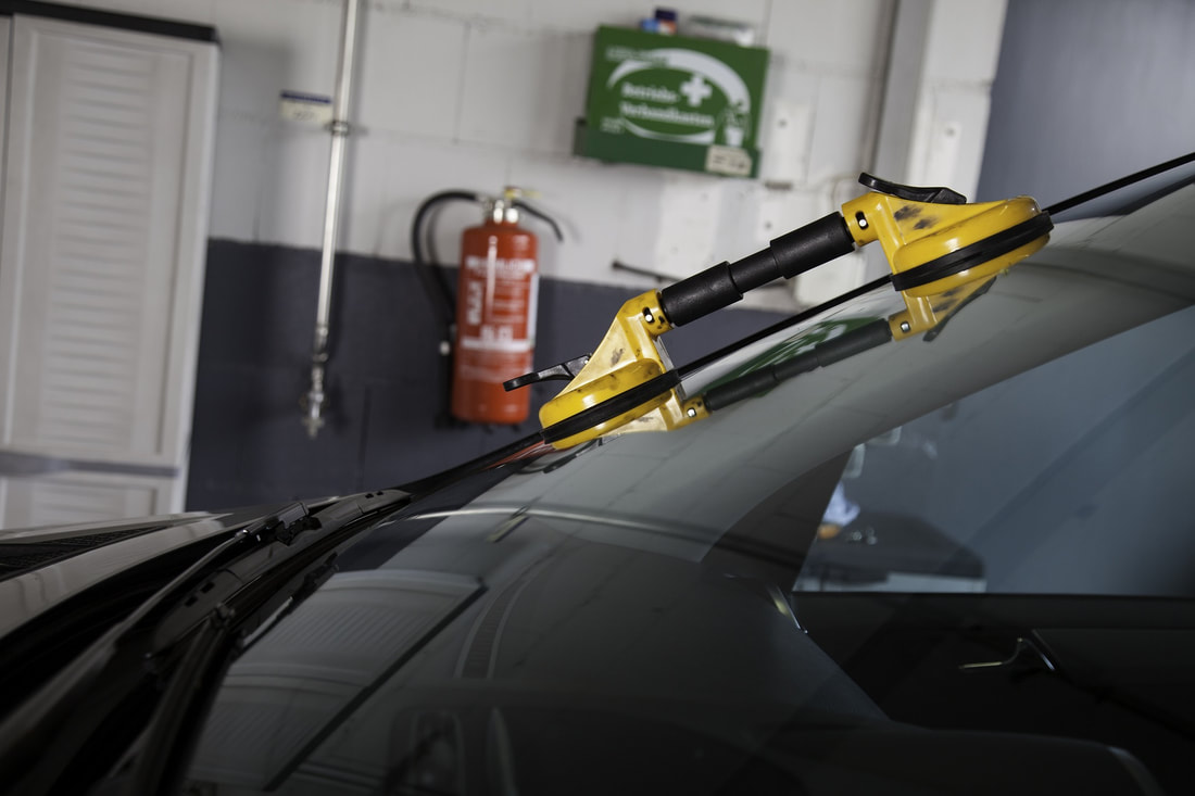Auto glass tool prepped on a windshield for an auto glass service