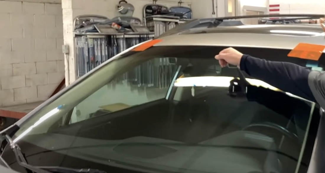 Auto glass technician getting a car ready to perform an auto glass service